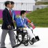 In this  Monday, Aug., 27, 2012 photo, North Korea's only competitor Rim Ju Song, sits in his wheelchair during the team's welcoming ceremony at the London 2012 Paralympic games in London.  Rim Ju Song, who actually lives in Beijing and lost an arm and leg in a construction accident, became his country's only hope. The problem: He couldn't really swim. The first training session was a disaster. He sank "like a rock," recalled Kim Sung Chol of the North Korean Paralympic Committee. Nevertheless, he soon learned the crawl stroke and in May, Rim and his coaches boarded a plane for Berlin and his first international competition. (AP Photo/Alastair Grant)