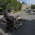 In this May 17, 2012 photo, Hairston Fullerton, a residing patient at Coler Goldwater Specialty Hospital & Nursing Facility on Roosevelt Island, drives his motorized wheelchair outside the facility's main entrance, in New York.  The Technion-Israel Institute of Technology in Haifa, Israel, is partnering with New York's Cornell University to create CornellNYC Tech, a 10-acre $2 billion campus, to  replace the acute long-term care hospital facility located on Roosevelt Island's southern end. (AP Photo/Bebeto Matthews)