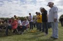 Church goers bow heads in prayer during open air Sunday service four days after deadly fertilizer plant explosion in West