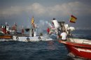Fernandez, head of the La Linea fishermen, holds a red flare to mark the end of their protest at the site where an artificial reef was built by Gibraltar, in Algeciras bay