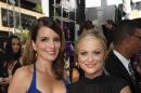 FILE - In this Sept. 22, 2013 file photo, Tina Fey, left, and Amy Poehler arrive at the 65th Primetime Emmy Awards at Nokia Theatre in Los Angeles. The duo will again lead the Hollywood Foreign Press Association's annual glitzy banquet Sunday, Jan. 12, 2014, where stars gather in a boozy dress rehearsal for the Oscars. (Photo by Matt Sayles/Invision for Academy of Television Arts & Sciences/AP Images)