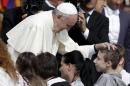 Pope Francis blesses a boy during his Wednesday general audience in Saint Peter's Square at the Vatican
