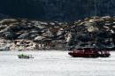 Rescuers work at a site where a helicopter has crashed west of the Norwegian city of Bergen