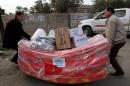 Displaced Iraqis who fled Anbar province's flashpoint al-Baghdadi district receive aid in the western Mansour Sunni neighbourhood of the capital, Baghdad, on February 24, 2015