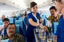 In this photo released by Sergey Dolya, cabin crew serve passengers during a flight over Jakarta, Indonesia, Wednesday, May 9, 2012. The Russian-made Sukhoi jet plane with 50 people on board, including eight Russians and an American, has gone missing during the second demonstration flight of the day near Jakarta, Indonesian government officials said Wednesday.(AP Photo/Sergey Dolya) NO SALES