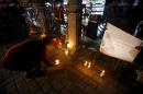 A woman places a candle at the site of Tuesday's suicide bomb attack at Sultanahmet square in Istanbul, Turkey