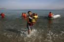 Iranian migrants arrive at the Greek island of Kos on a dinghy