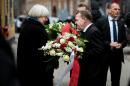 Danish Prime Minister Lars Lokke Rasmussen (R) and Mayor of Copenhagen Frank Jensen speak to Bodil Uzan (L), mother of Dan Uzan who was killed while working as a security guard at a synagoge, during a commemoration in Copenhagen on February 14, 2016