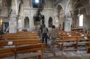 Iraqi special forces soldiers walk inside a church damaged by Islamic States fighters in Bartella, east of Mosul, Iraq