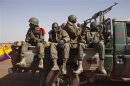 Malian soldiers heading to Gao in a pickup truck arrive in the recently liberated town of Douentza