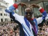 Long distance runner Mo Farah makes his trademark "Mobot" pose during a parade of British Olympic and Paralympic athletes through London
