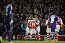 Arsenal's Alexis Sanchez is celebrated by teammates after scoring his side's second goal during a Champions League, Group D soccer match between Arsenal and Anderlecht, at the Emirates Stadium, in London, Tuesday, Nov. 4, 2014. (AP Photo/Matt Dunham)
