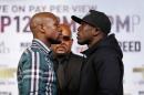 Boxers Floyd Mayweather Jr., left, and Andre Berto pose for photographers during a news conference Wednesday, Sept. 9, 2015, in Las Vegas. The pair are scheduled to fight Saturday for Mayweather's WBC and WBA Super World welterweight titles. (AP Photo/John Locher)