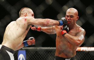 Rory MacDonald and Robbie Lawler trade blows during their UFC 189 fight. (AP)