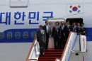 South Korean government officials and lawmakers accompanying President Park Geun-hye arrive at the airport in Beijing