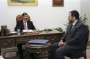 Egypt's President Mohamed Mursi meets with Water Minister Hisham Kandil at the presidential palace in Cairo