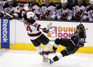 New Jersey Devils' Bryce Salvador (24) and Los Angeles Kings' Dustin Brown (23) collide in the first period during Game 4 of the NHL hockey Stanley Cup finals, Wednesday, June 6, 2012, in Los Angeles.  (AP Photo/Jae C. Hong)