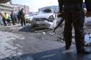 Iraqi police stand guard at the site of a car bomb in central Baghdad, on January 15, 2014