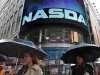 Commuters pass by the NASDAQ Marketsite in New York