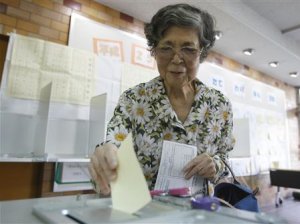 A woman casts her ballot at a polling station in T …