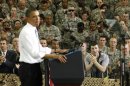 A soldier wounded in Afghanistan applauds as U.S. President Barack Obama speaks to troops at Fort Campbell in Kentucky