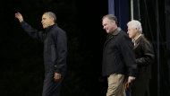 President Barack Obama, left, is joined by former President Bill Clinton, right, and Democratic candidate for the U.S. Senate from Virginia, former Gov. Tim Kaine, center, on stage at a rally at Jiffy Lube Live arena, late Saturday night, Nov. 3, 2012, in Bristow, Va. (AP Photo/Pablo Martinez Monsivais)