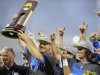 UCLA coach John Savage is surrounded by players as he hoists the trophy after beating Mississippi State 8-0 in Game 2 of the NCAA College World Series baseball finals, Tuesday, June 25, 2013, in Omaha, Neb., winning the championship. (AP Photo/Eric Francis)