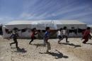 Internally displaced children run inside a refugee camp in Dana town after fleeing Palmyra, in northern Idlib province