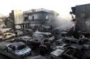 Burned cars are seen in a car lot as a wildfire rages at the town of Neapoli in the region of Laconia in Peloponnese