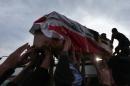 The coffin of one of three special forces officers arrives in the holy Shiite Muslim city of Najaf, in central Iraq, on March 5, 2014