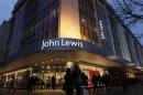 Shoppers pass in front of John Lewis department store in Oxford Street in central London