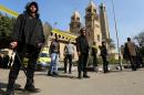 FILE PHOTO: Members of the special police forces stand guard to secure the area around St. Mark's Coptic Orthodox Cathedral after an explosion inside the cathedral in Cairo