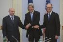 U.S. Secretary of State John Kerry, center, greets Ukrainian Prime Minister Arseniy Yatsenyuk, right, and parliament speaker Oleksandr Turchynov prior their meting in Kiev, Ukraine, Tuesday, March, 4, 2014. In a somber show of U.S. support for Ukraine's new leadership, Secretary of State John Kerry walked the streets Tuesday where nearly 100 anti-government protesters were gunned down by police last month, and promised beseeching crowds that American aid is on the way. The Obama administration announced a $1 billion energy subsidy package in Washington as Kerry was arriving in Kiev.( (AP Photo/Andrew Kravchenko, pool)