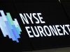 A NYSE Euronext sign is seen over the the floor of the New York Stock Exchange