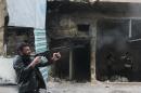 A rebel fighter from the Free Syrian Army fires his weapon during fighting against government forces on November 18, 2013 in the Salah al-Din neighbourhood of the northern Syrian city of Aleppo