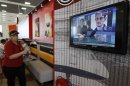 A television shows former U.S. spy agency contractor Snowden at a cafe in Moscow's Sheremetyevo airport