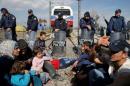 Migrants block the railway track at the Greek-Macedonian border, near the village of Idomeni