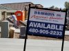 In this Nov. 9, 2011 photo, a construction worker hauls supplies into a new DR Horton home, in Chandler, Ariz.  Homebuilder D.R. Horton Inc. said FRiday, Nov. 11, 2011, it returned to a profit in the fiscal fourth-quarter as more people bought homes. (AP Photo/Matt York)