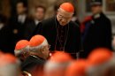 Vatican chamberlain Cardinal Tarcisio Bertone (standing) has the daunting job of keeping the conclave leak-proof.