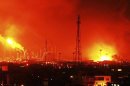 Fire rises over Amuay refinery near Punto Fijo, Venezuela, Saturday, Aug. 25, 2012. A huge explosion rocked Venezuela's biggest oil refinery, killing at least 19 people and injuring dozens, an official said. (AP Photo/Daniela Primera)