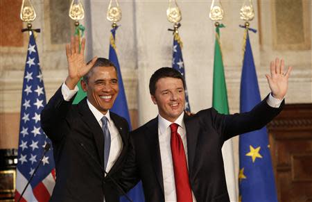U.S. President Obama and Italian Prime Minister Renzi wave at the end of their conference following their meeting at Villa Madama in Rome