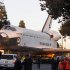 The space shuttle Endeavour slowly moves down Martin Luther King Blvd. in Los Angeles,  Sunday, Oct.14, 2012. In thousands of Earth orbits, the space shuttle Endeavour traveled 123 million miles (198 million kilometers). But the last few miles (kilometers) of its final journey are proving hard to get through. Endeavour's 12-mile (19-kilometer) crawl across Los Angeles to the California Science Museum hit repeated delays Saturday, leaving expectant crowds along city streets and at the destination slowly dwindling. Officials estimated the shuttle, originally expected to finish the trip early Saturday evening, would not arrive until mid-morning Sunday.  (AP Photo/Alex Gallardo)