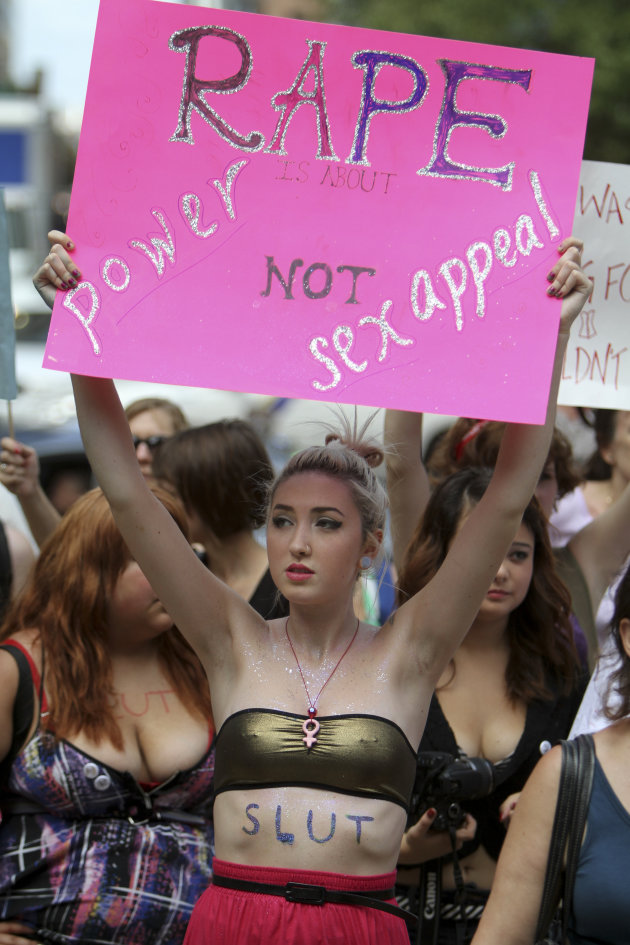 Elli Rego holds up a sign while participating in the Slut Walk demonstration in Philadelphia, on Saturday, Aug. 6, 2011.  Organizers of the walk aim to raise awareness for women’s issues including the
