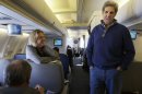 U.S. Secretary of State John Kerry, center, visits with the traveling media aboard a plane en route to London on his inaugural trip as secretary on Sunday, Feb. 24, 2013. (AP Photo/Jacquelyn Martin, Pool)