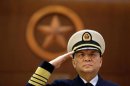 Commander of PLA Navy Wu salutes during a welcoming ceremony in Beijing
