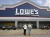 FILE - In this Feb. 20, 2011 file photo, a couple enters a Lowe's store in Dallas. Lowe's Cos. said Monday, Nov. 14, 2011, its third-quarter earnings sank 44 percent, weighed down by charges tied to store closings and discontinued projects. (AP Photo/LM Otero, File)