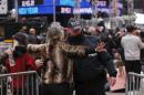 A woman is searched by a New York Police Department officer as she enters a pen to wait for the beginning of New Year's Eve festivities in the Times Square area of New York